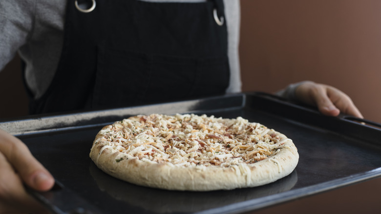 Frozen pizza on baking tray