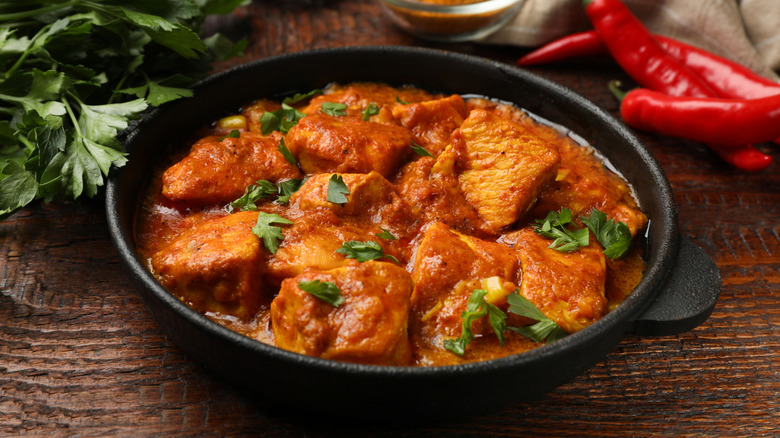 Cast iron pan of chicken tikka masala