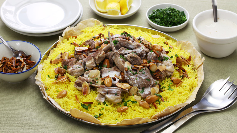 Traditional Jordanian dish Mansaf with rice, lamb, and sliced nuts