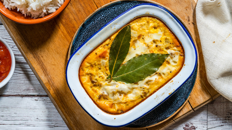 Dish of baked bobotie with curried minced meat
