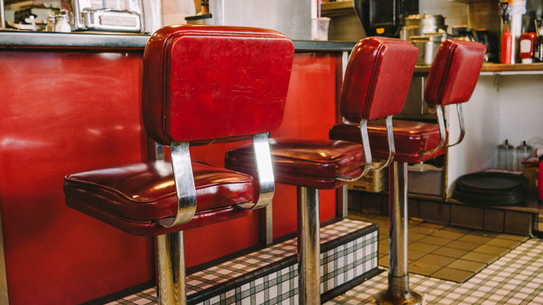 Old fashioned stools lined up at a retro lunch counter