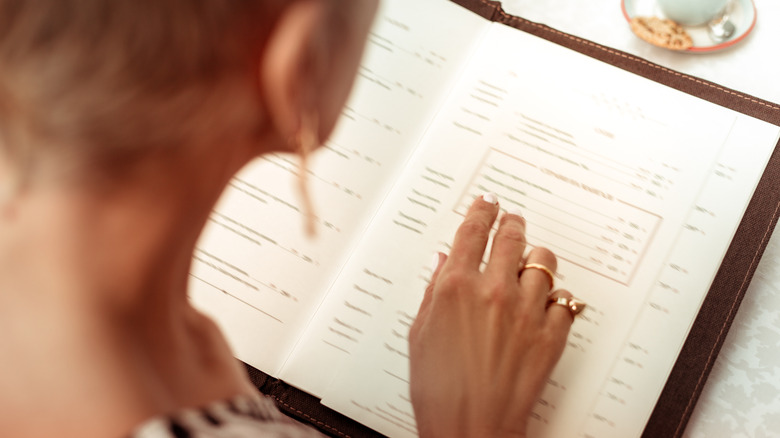 person looking at restaurant menu