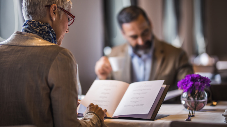 couple looking at restaurant menus