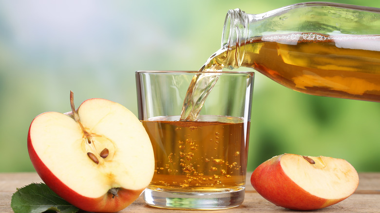 Apple juice being poured into a glass