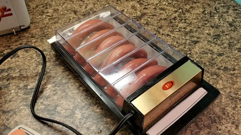 The Presto Hot Dogger sits on a marble counter top, filled with hot dgs