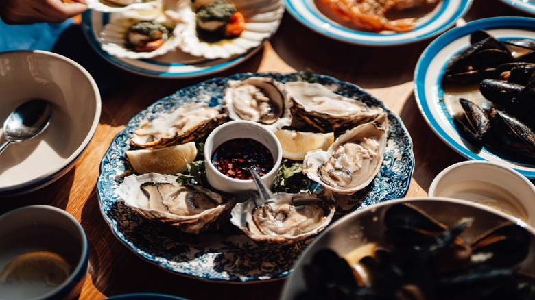 Various seafood dishes served on plates