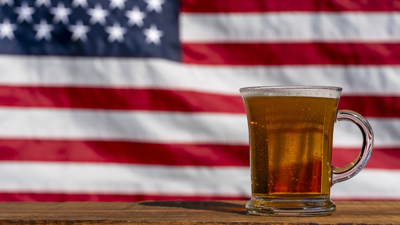 A pint of beer sitting in front of the American flag