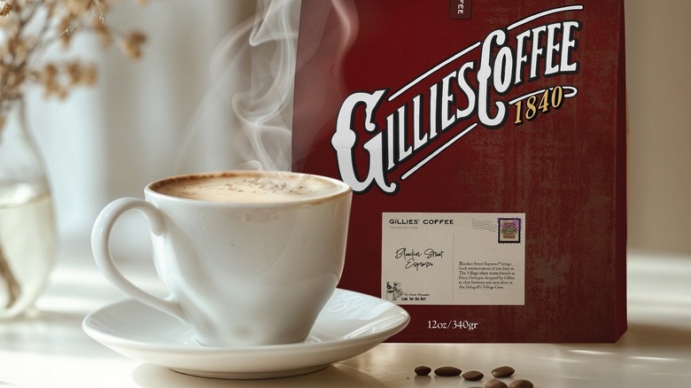 A Gillies Coffee bag next to a cup of coffee