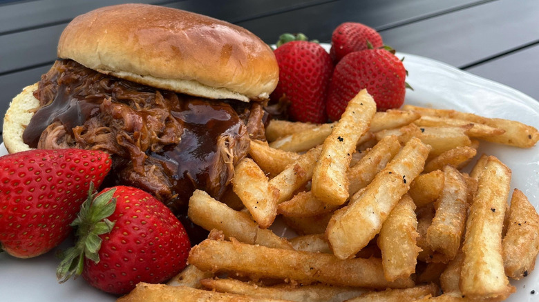 A plate of barbecue pork, strawberries, and fries at historic Long Grove Village Tavern.
