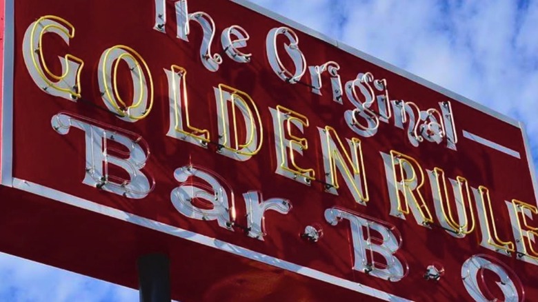 Neon sign for The Golden Rule restaurant during the day