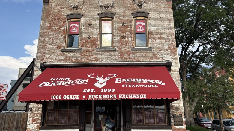 Brick front with red awning outside the Buckhorn Exchange