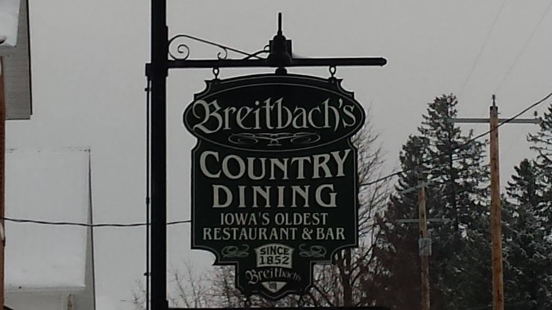 Hanging sign for Breitbach's on a winter day