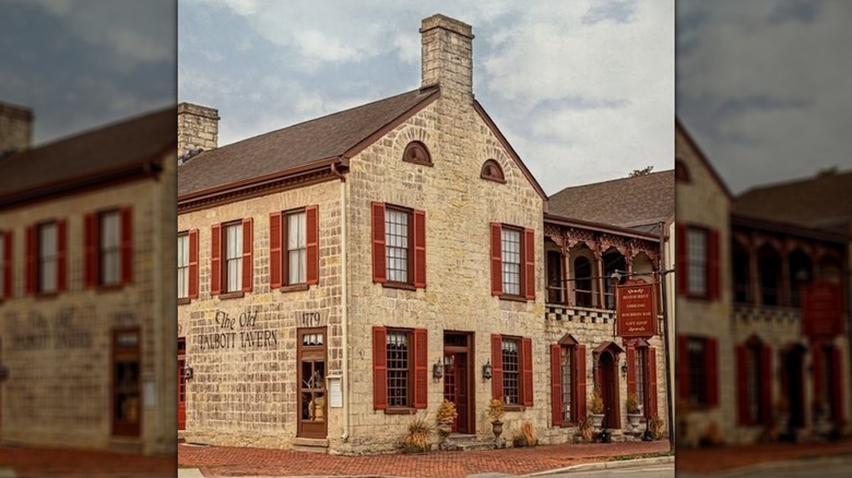 Red shutters adorn the worn exterior of The Old Talbott Tavern