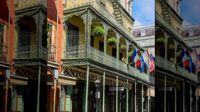 Flags protrude from the balcony above the entrance to Antoine's Restaurant