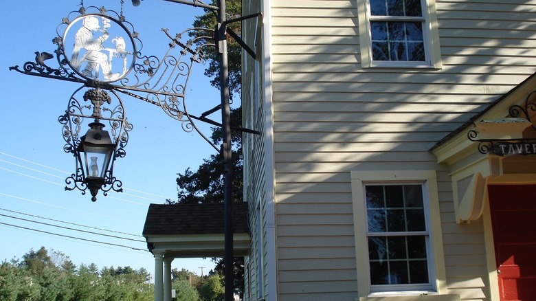 Ornate sign hangs off the side of Ye Olde Centerton Inn
