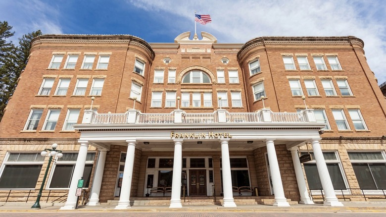 White columns stand before the brick facade of the Franklin Hotel
