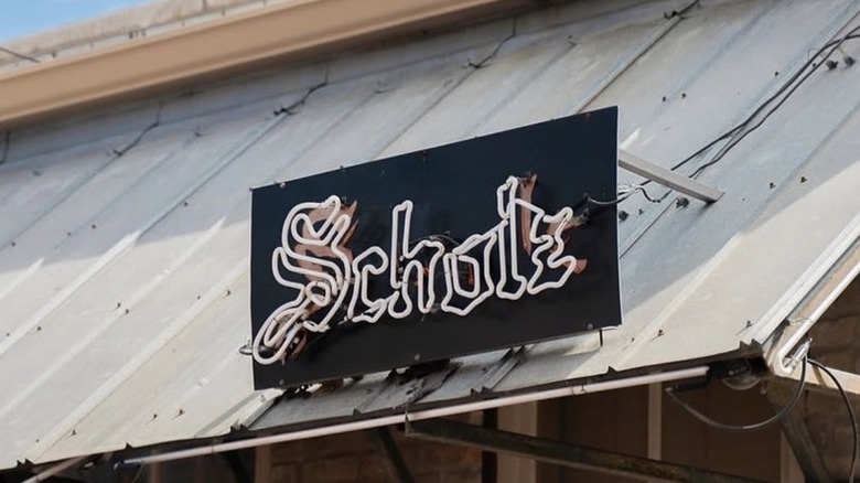 Unlit neon Scholz sign affixed to an overhang