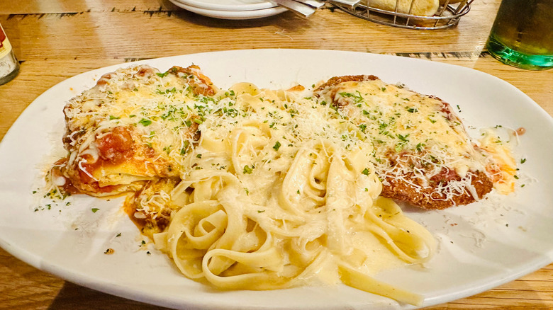 Olive Garden's Tour of Italy dish, which features lasagna classico, fettuccini alfredo, and chicken Parmigiana