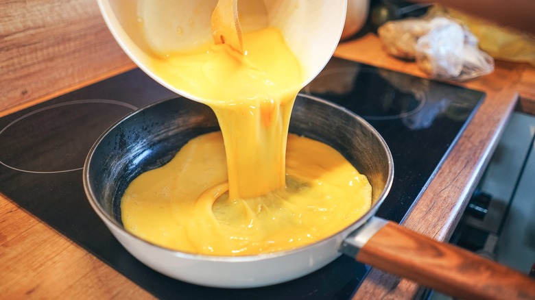 Pouring eggs in hot pan