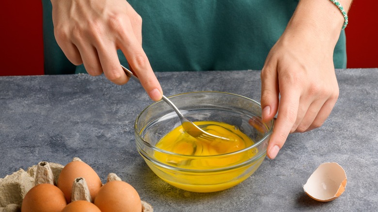 Woman scrambling eggs