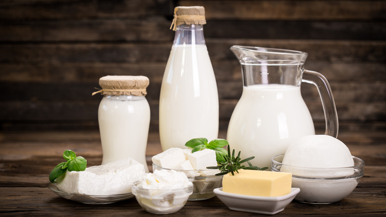 Various milks, butters, and cheeses on wooden table