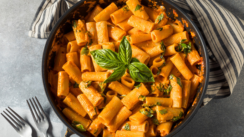 Rigatoni pasta with vodka sauce in a black bowl