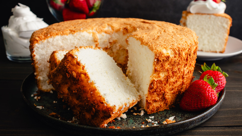 Sliced angel food cake with strawberries and whipped cream