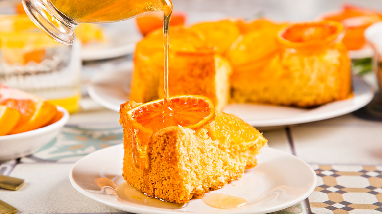 orange cake with a syrup being poured on it