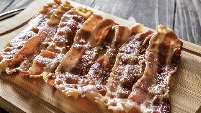 Crispy bacon on wooden cutting board