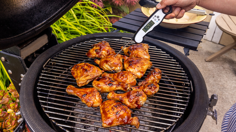 Checking grilled chicken temperature