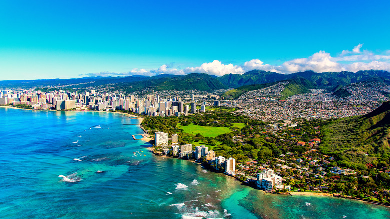 The coastline of Honolulu sits against brilliant blue water
