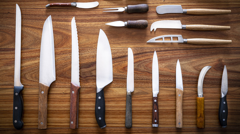 Kitchen knives on wood background