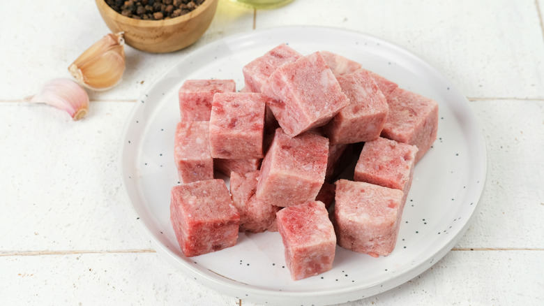 Frozen cubes of beef.