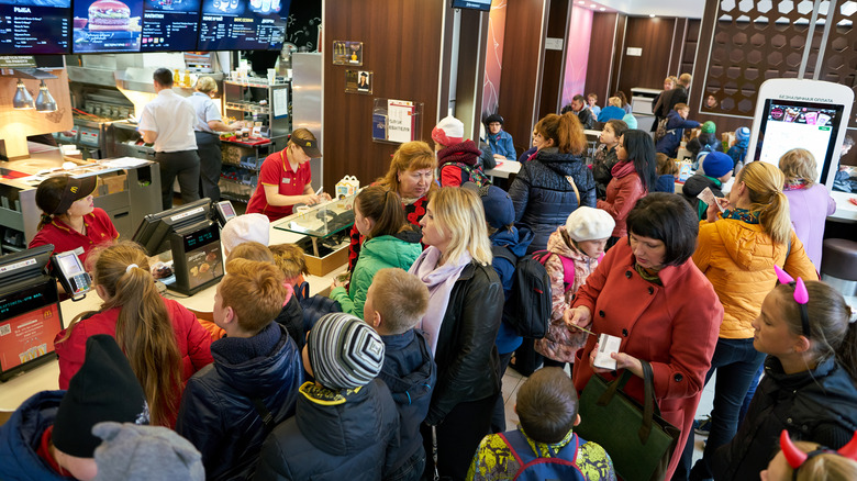 The interior of a McDonald's is extremely crowded with people