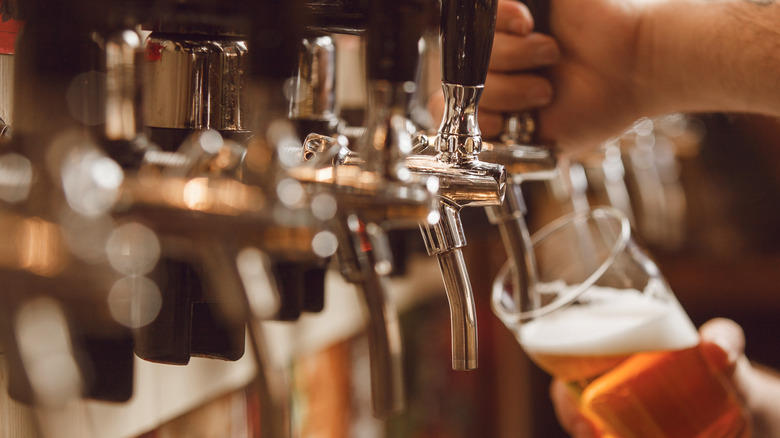 Beer being poured from a tap.