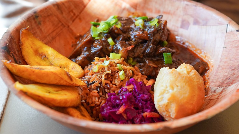 Oxtail served with fried plantains and sides