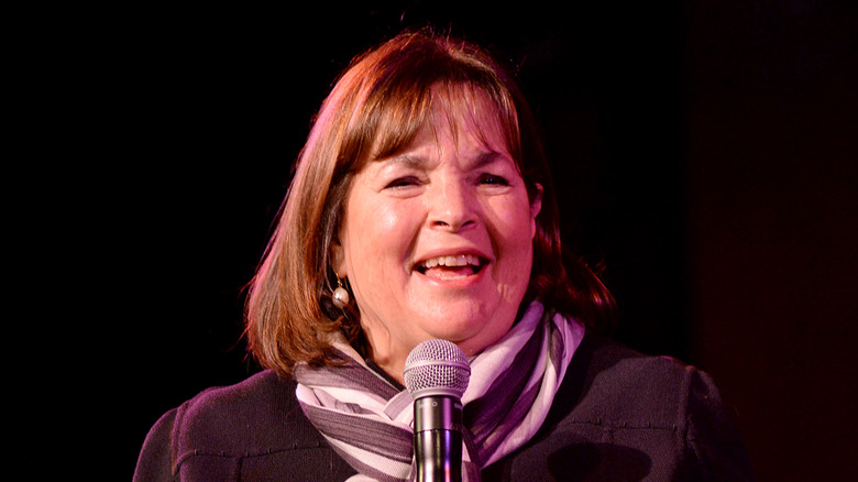 Ina Garten laughing and holding a microphone