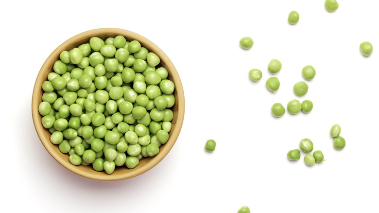 Peas in a bowl on a white background