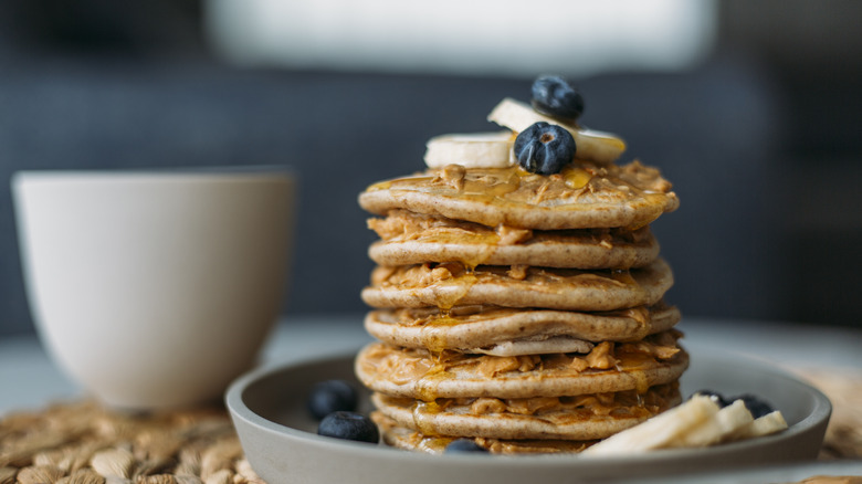Whole wheat pancakes topped with berries and banana