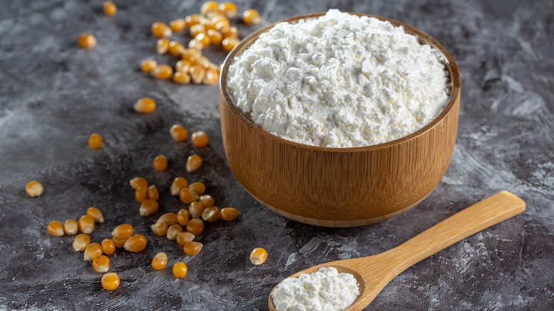 Bowl and spoonful of cornstarch with corn kernels