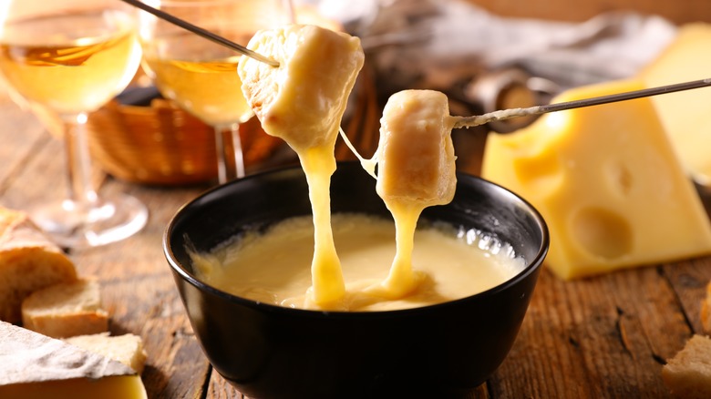 Cubes of bread dipped into cheese fondue