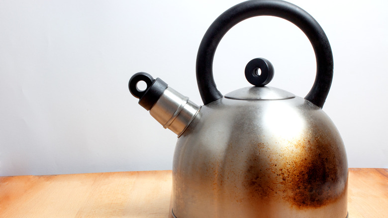 Rusty teapot on a wooden surface