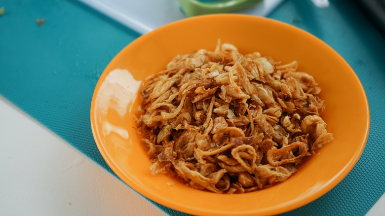 A bowl of crispy friend onion strings