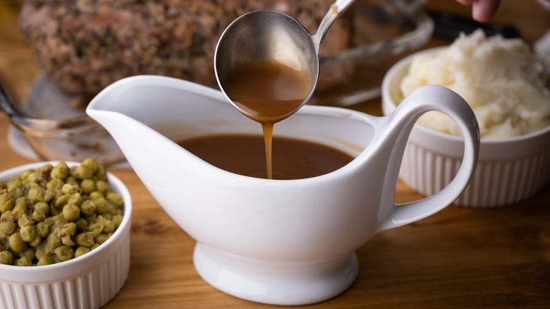 brown gravy ladled into pitcher