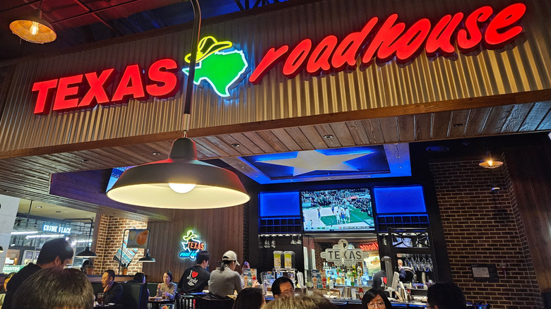 Texas Roadhouse interior showing people sitting at bar and in booths