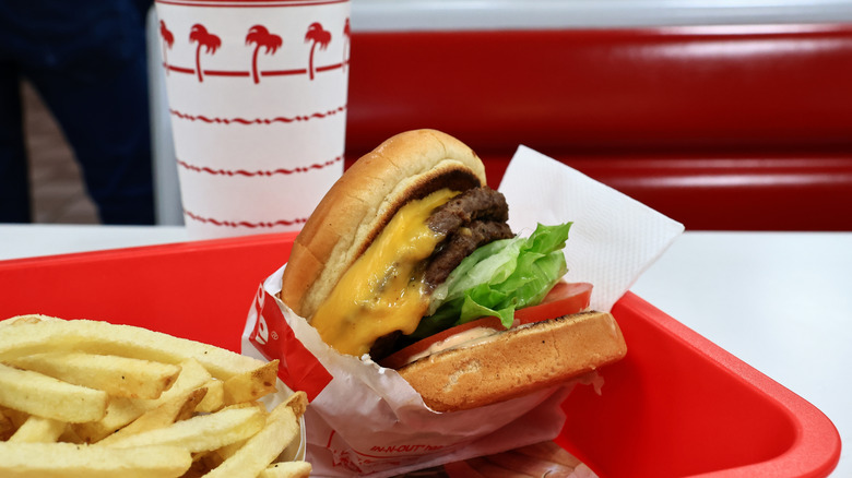 A Double double from In-N-Out next to some fries.