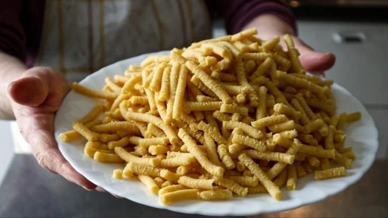 Raw passatelli pasta on plate