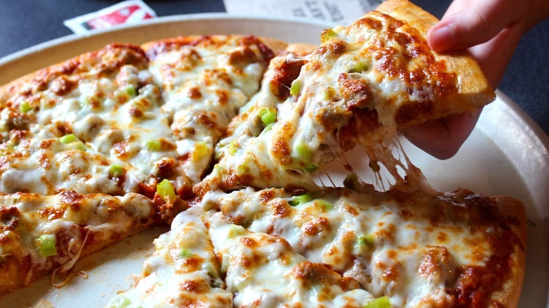 Someone takes a slice of Godfather's Pizza.