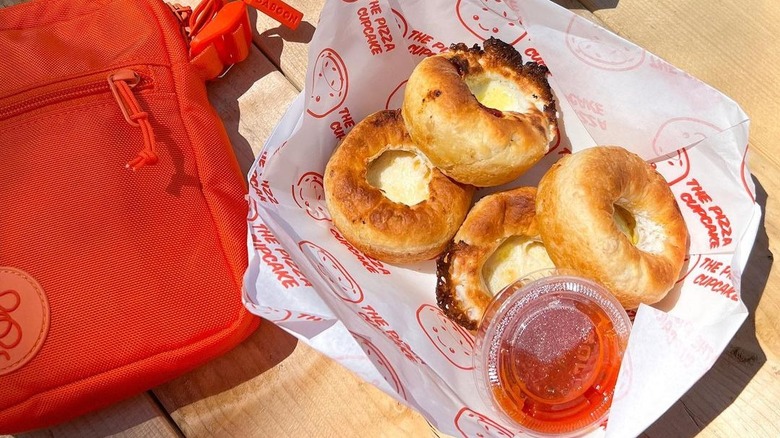 Pizza cupcakes on a table by bag