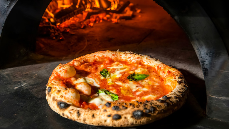Pizza Margherita (Neapolitan pizza) straight from a wood-fired oven.